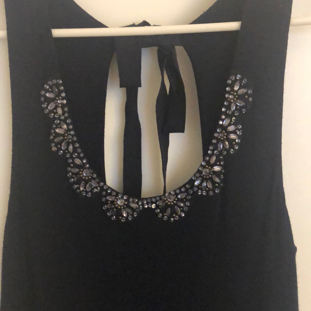 Sleeveless navy dress with beading around neckline